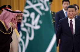 Xi Jinping welcomed Saudi King Salman as China continues a charm offensive toward the Middle East, a region where it has long kept a low profile. / AFP PHOTO / NICOLAS ASFOURI