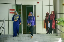 Some civil servants pictured at the entrance to the main government office complex 'Velaanaage' in the capital Male. MIHAARU PHOTO/NISHAN ALI