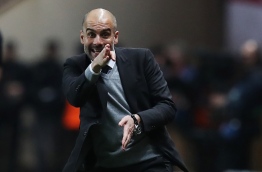 Manchester City's Spanish manager Pep Guardiola reacts during the UEFA Champions League round of 16 football match between Monaco and Manchester City at the Stade Louis II in Monaco on March 15, 2017. / AFP PHOTO / Valery HACHE