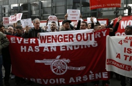 Arsenal supporters calling for the end of the reign of Arsenal's French manager Arsene Wenger, arrive at the stadium with their placards ahead of the English FA cup quarter final football match between Arsenal and Lincoln City at The Emirates Stadium in London on March 11, 2017. / AFP PHOTO / Ian KINGTON / RESTRICTED TO EDITORIAL USE. No use with unauthorized audio, video, data, fixture lists, club/league logos or 'live' services. Online in-match use limited to 75 images, no video emulation. No use in betting, games or single club/league/player publications. /