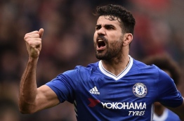 Chelsea's Brazilian-born Spanish striker Diego Costa celebrates their second goal during the English Premier League football match between Stoke City and Chelsea at the Bet365 Stadium in Stoke-on-Trent, central England on March 18, 2017. / AFP PHOTO / Oli SCARFF / RESTRICTED TO EDITORIAL USE. No use with unauthorized audio, video, data, fixture lists, club/league logos or 'live' services. Online in-match use limited to 75 images, no video emulation. No use in betting, games or single club/league/player publications. /