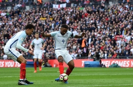 England's striker Jermain Defoe (C) shoots to score his team's first goal during the World Cup 2018 qualification football match between England and Lithuania at Wembley Stadium in London on March 26, 2017. / AFP PHOTO / Glyn KIRK / NOT FOR MARKETING OR ADVERTISING USE / RESTRICTED TO EDITORIAL USE