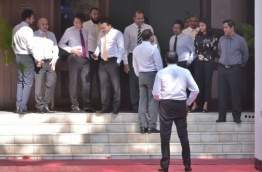 Lawmakers pictured outside the parliament ahead of a debate. PHOTO: HUSSAIN WAHEED/MIHAARU