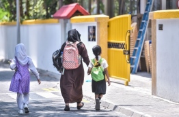 A parent accompanying a student to Thaajuddeen School. PHOTO: HUSSAIN WAHEED/MIHAARU