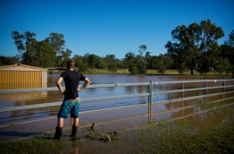 Rising floods continued to plague parts of eastern Australia as emergency workers battled to restore water and electricity in cyclone-hit areas on April 2, with the recovery efforts expected to last several months. / AFP PHOTO / Patrick HAMILTON