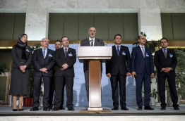 Syrian chief negotiator and Ambassador of the Permanent Representative Mission of Syria to the United Nations Bashar al-Jaafari (C) speaks next to members of the government delegation during a press conference following a metting with UN Special Envoy for Syria during Syria peace talks in Geneva on March 31, 2017 / AFP PHOTO / Fabrice COFFRINI
