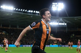 Hull City's English defender Harry Maguire celebrates scoring his team's fourth goal during the English Premier League football match between Hull City and Middlesbrough at the KCOM Stadium in Kingston upon Hull, north east England on April 5, 2017. / AFP PHOTO / Lindsey PARNABY / RESTRICTED TO EDITORIAL USE. No use with unauthorized audio, video, data, fixture lists, club/league logos or 'live' services. Online in-match use limited to 75 images, no video emulation. No use in betting, games or single club/league/player publications. /