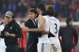 Chelsea's Italian head coach Antonio Conte (L) embraces Chelsea's Brazilian-born Spanish striker Diego Costa (R) at the end of the English Premier League football match between Bournemouth and Chelsea at the Vitality Stadium in Bournemouth, southern England on April 8, 2017. / AFP PHOTO / Glyn KIRK / RESTRICTED TO EDITORIAL USE. No use with unauthorized audio, video, data, fixture lists, club/league logos or 'live' services. Online in-match use limited to 75 images, no video emulation. No use in betting, games or single club/league/player publications. /