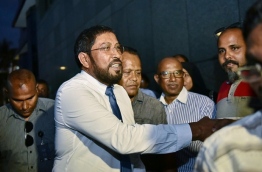 Jumhoory Party leader Qasim Ibrahim shakes hands with supporters after an interrogation at Police headquarters. PHOTO: HUSSAIN WAHEED/MIHAARU