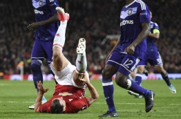 Manchester United's Swedish striker Zlatan Ibrahimovic goes down holding his knee during the UEFA Europa League quarter-final second leg football match between Manchester United and Anderlecht at Old Trafford in Manchester, north west England, on April 20, 2017. / AFP PHOTO / Oli SCARFF