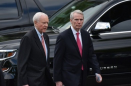 Senators Orin Hatch (L), R-UT, and Rob Portman, R-OH, are seen on West Executive Drive after a briefing for US senators on the situation in North Korea in the Eisenhower Executive Office Building, next to the White House on April 26, 2017 in Washington, DC. / AFP PHOTO / MANDEL NGAN