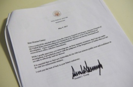 A copy of the termination letter to FBI Director James Comey from US President Donald Trump is seen at the White House on May 9, 2017 in Washington, DC. / AFP PHOTO / MANDEL NGAN