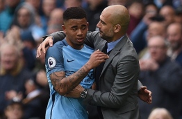 Manchester City's Brazilian striker Gabriel Jesus (L) is hugged by Manchester City's Spanish manager Pep Guardiola as he substituted off of the pitch during the English Premier League football match between Manchester City and Crystal Palace at the Etihad Stadium in Manchester, north west England, on May 6, 2017. / AFP PHOTO / Oli SCARFF / RESTRICTED TO EDITORIAL USE. No use with unauthorized audio, video, data, fixture lists, club/league logos or 'live' services. Online in-match use limited to 75 images, no video emulation. No use in betting, games or single club/league/player publications. /