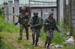 Hundreds of Islamist gunmen rampaged through the city of 200,000, the Islamic capital of the mainly Catholic Philippines, on May 23 after government forces attempted to arrest their leader, Isnilon Hapilon. Up to 50 gunmen continued to control downtown Marawi nearly two weeks later with at least 15 hostages including a Catholic priest, with some being used as human shields, the military said. / AFP PHOTO / Noel CELIS