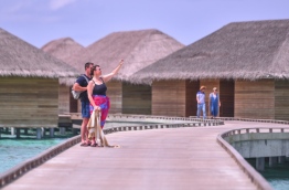 Tourists on the walkway leading to the water villas in Cocoon Maldives resort. PHOTO: HUSSAIN WAHEED/MIHAARU