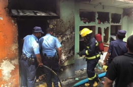 Police and MNDF officers at a scene of a fire after a gas explosion. PHOTO: NISHAN ALI/MIHAARU