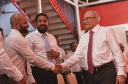 Former President Maumoon Abdul Gayoom (R) shakes hands with his lawmaker son Faris Maumoon PHOTO:Hussain Waheed/Mihaaru