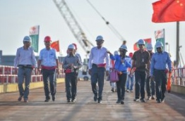Housing Minister Dr Muizzu (C) walks along the China-Maldives Friendship Bridge. PHOTO: HUSSAIN WAHEED/MIHAARU
