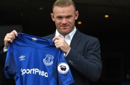 Rooney, whose move comes after United announced they had agreed terms with Everton over buying striker Romelu Lukaku, will hope the switch revives his international career. / AFP PHOTO / Paul ELLIS