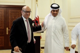French Minister of Europe and Foreign Affairs Jean-Yves Le Drian (L) embraces his Qatari counterpart Mohammed bin Abdulrahman al-Thani as they walk out of a press conference in the Qatari capital Doha on July 15, 2017. / AFP PHOTO / STRINGER