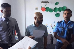 MP Faris Maumoon (C) with police officers