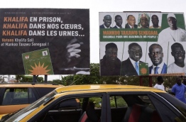 This picture taken on July 29, 2017, in Dakar, shows electoral posters on the eve of legislatives elections. / AFP PHOTO / SEYLLOU