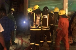 MNDF firefighters at work to put out a fire in a warehouse building in Hulhumale