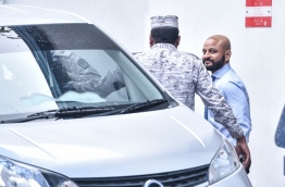 Dhiggaru MP Faris Maumoon escorted back to jail after a hearing at the Criminal Court. PHOTO: HUSSAIN WAHEED/MIHAARU