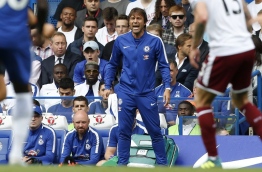 Chelsea's Italian head coach Antonio Conte gestures on the touchline during the English Premier League football match between Chelsea and Burnley at Stamford Bridge in London on August 12, 2017. / AFP PHOTO / Ian KINGTON / RESTRICTED TO EDITORIAL USE. No use with unauthorized audio, video, data, fixture lists, club/league logos or 'live' services. Online in-match use limited to 75 images, no video emulation. No use in betting, games or single club/league/player publications. /