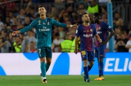 Real Madrid's Portuguese forward Cristiano Ronaldo (L) gestures as he leaves the field after receiving his second yellow card during the Spanish Supercup first leg football match FC Barcelona vs Real Madrid at the Camp Nou stadium in Barcelona on August 13, 2017. / AFP PHOTO / LLUIS GENE