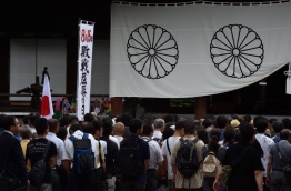 Japan's Prime Minister Shinzo Abe on August 15 sent a cash donation to the controversial war shrine as the country marked the anniversary of its defeat in World War II. / AFP PHOTO / Kazuhiro NOGI