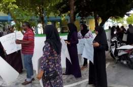 Parents gather outside GDh Thinadhoo's atoll education centre to protest the impending termination of two teachers who took part in an opposition political rally.