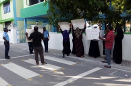 Parents gather outside GDh Thinadhoo’s atoll education centre to protest the impending termination of two teachers who took part in an opposition political rally.