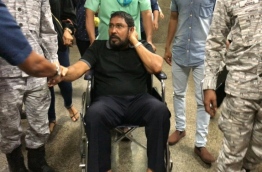 Opposition Jumhoory Party (JP) leader Qasim Ibrahim being taken to Velana International Airport (VIA) by Maldives Correctional Service (MCS) officers. He was given permission to depart to Singapore on Wednesday evening.