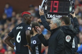 Manchester United's Portuguese manager Jose Mourinho (2R) gives instructions to Manchester United's French midfielder Paul Pogba (L) during the English Premier League football match between Stoke City and Manchester United at the Bet365 Stadium in Stoke-on-Trent, central England on September 9, 2017. / AFP PHOTO / Geoff CADDICK / RESTRICTED TO EDITORIAL USE. No use with unauthorized audio, video, data, fixture lists, club/league logos or 'live' services. Online in-match use limited to 75 images, no video emulation. No use in betting, games or single club/league/player publications. /