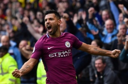 Manchester City's Argentinian striker Sergio Aguero celebrates scoring his third and the team's fifth goal during the English Premier League football match between Watford and Manchester City at Vicarage Road Stadium in Watford, north of London on September 16, 2017. / AFP PHOTO / Ben STANSALL / RESTRICTED TO EDITORIAL USE. No use with unauthorized audio, video, data, fixture lists, club/league logos or 'live' services. Online in-match use limited to 75 images, no video emulation. No use in betting, games or single club/league/player publications. /