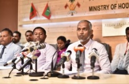 Housing Minister Mohamed Muizzu (R) speaks at housing ministry press conference regarding the distribution of flats from the government's first social housing project. PHOTO: HUSSAIN WAHEED/MIHAARU