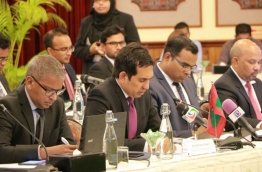 Economic Minister Mohamed Saeed (C) pictured at a free trade discussion.