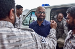 Former Managing Director of Maldives Marketing and Public Relations Corporation (MMPRC) Abdhullah Ziyath being escorted to the police with Maldives Correctional Service (MCS) staff. PHOTO / MIHAARU