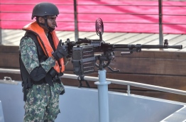 A solider pictured at an artillery aboard an MNDF naval vessel. PHOTO: NISHAN ALI/MIHAARU