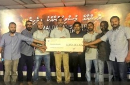 Staff of MPL pose with a cheque of MVR 1.3 million donated to the Maldivians With Rohingya fund. PHOTO/MPL