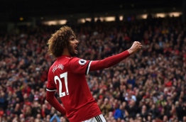 Manchester United's Belgian midfielder Marouane Fellaini celebrates scoring the team's second goal during the English Premier League football match between Manchester United and Crystal Palace at Old Trafford in Manchester, north west England, on September 30, 2017. / AFP PHOTO / PAUL ELLIS / RESTRICTED TO EDITORIAL USE. No use with unauthorized audio, video, data, fixture lists, club/league logos or 'live' services. Online in-match use limited to 75 images, no video emulation. No use in betting, games or single club/league/player publications. /