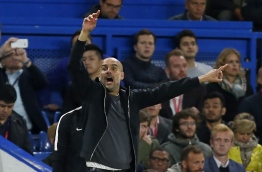 Manchester City's Spanish manager Pep Guardiola gestures on the touchline during the English Premier League football match between Chelsea and Manchester City at Stamford Bridge in London on September 30, 2017. / AFP PHOTO / Ian KINGTON / RESTRICTED TO EDITORIAL USE. No use with unauthorized audio, video, data, fixture lists, club/league logos or 'live' services. Online in-match use limited to 75 images, no video emulation. No use in betting, games or single club/league/player publications. /