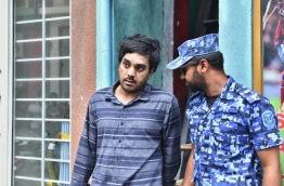 Police arrest Afrah Abdul Razzaq, 21, a suspect wanted in connection to the murder of Mohamed Anas. PHOTO: HUSSAIN WAHEED/MIHAARU