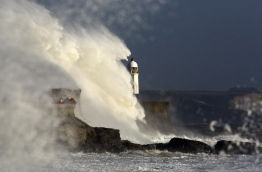 Ireland was hit by an "unprecedented storm" on Monday that left two people dead, 120,000 homes and businesses without power and closed every school in the country. The storm also sent strong winds over the southwest of England and the south and west of Wales. / AFP PHOTO / Geoff CADDICK