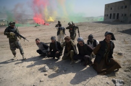 Afghan National Army (ANA) soldiers participated in the exercise mission to demonstrate their combat training in front of members of the local and international media. / AFP PHOTO / SHAH MARAI