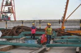 Staff of CCCC Second Harbour Engineering Company at work on the site of the Male-Hulhule bridge. PHOTO/MIHAARU
