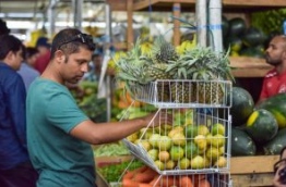 Man at a fruit stall in the Travellers' Market, Male. PHOTO: NISHAN ALI/MIHAARU