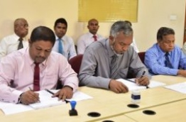 Former MRDC head Ibrahim Nazeem (L) pictured signing an agreement with the housing ministry.