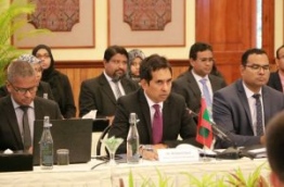 Economic Minister Mohamed Saeed (C) pictured at a free trade discussion.